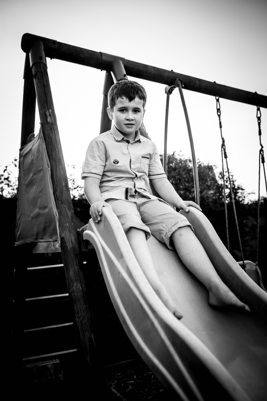 Photo of Daragh sitting on a slide.