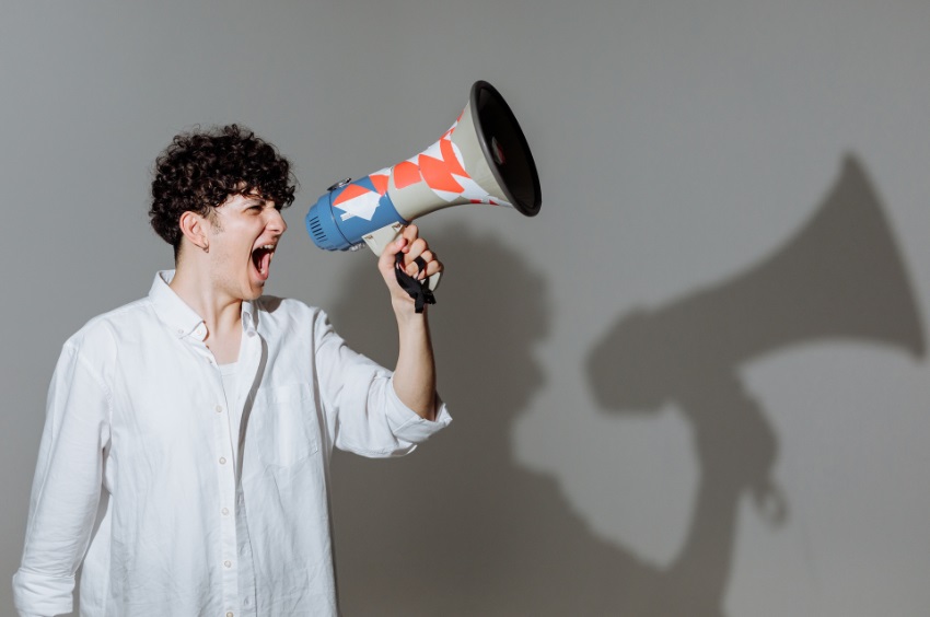 Photo of a young person with a loud speaker