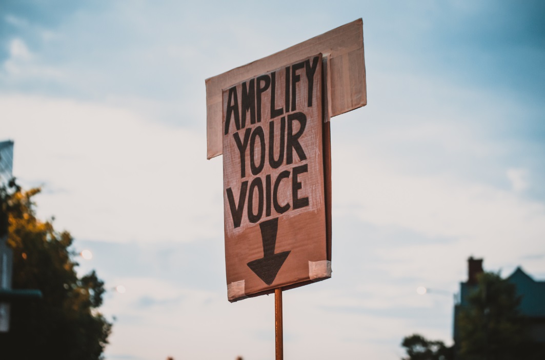 Poster with 'amplify your voice' 