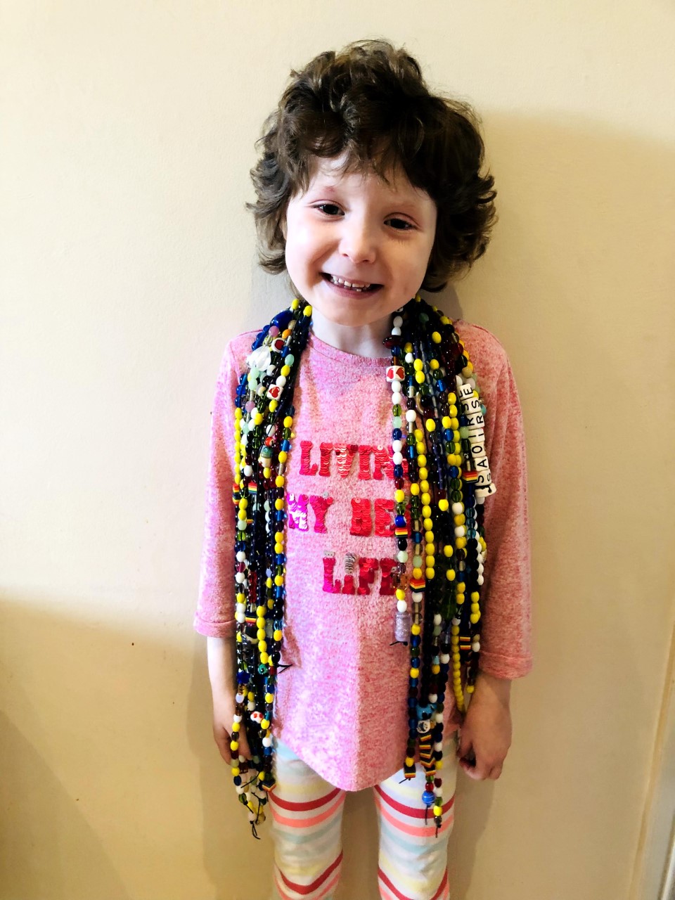 Photo of Saoirse wearing her long string of Beads of Courage