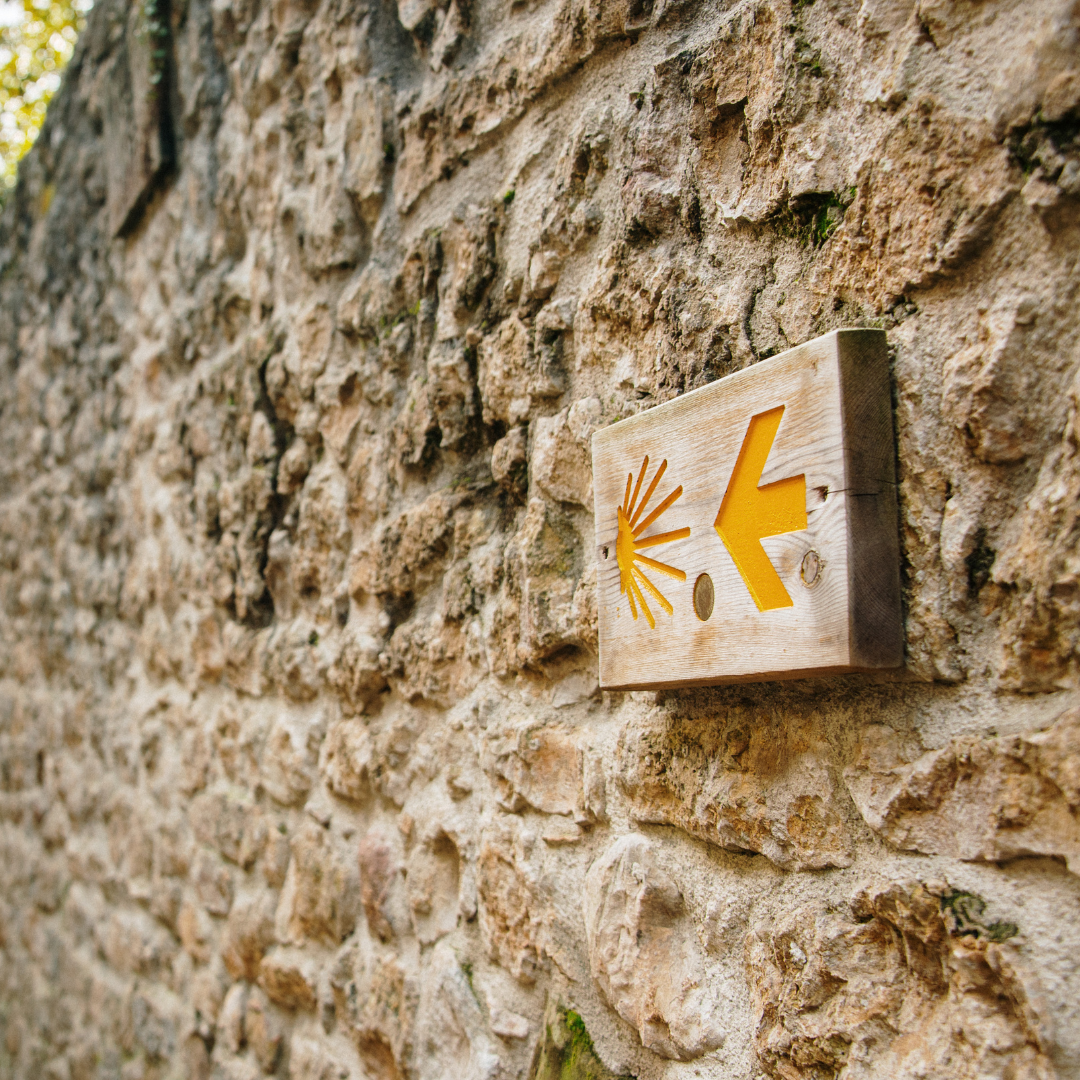 Camino sign on a brick wall