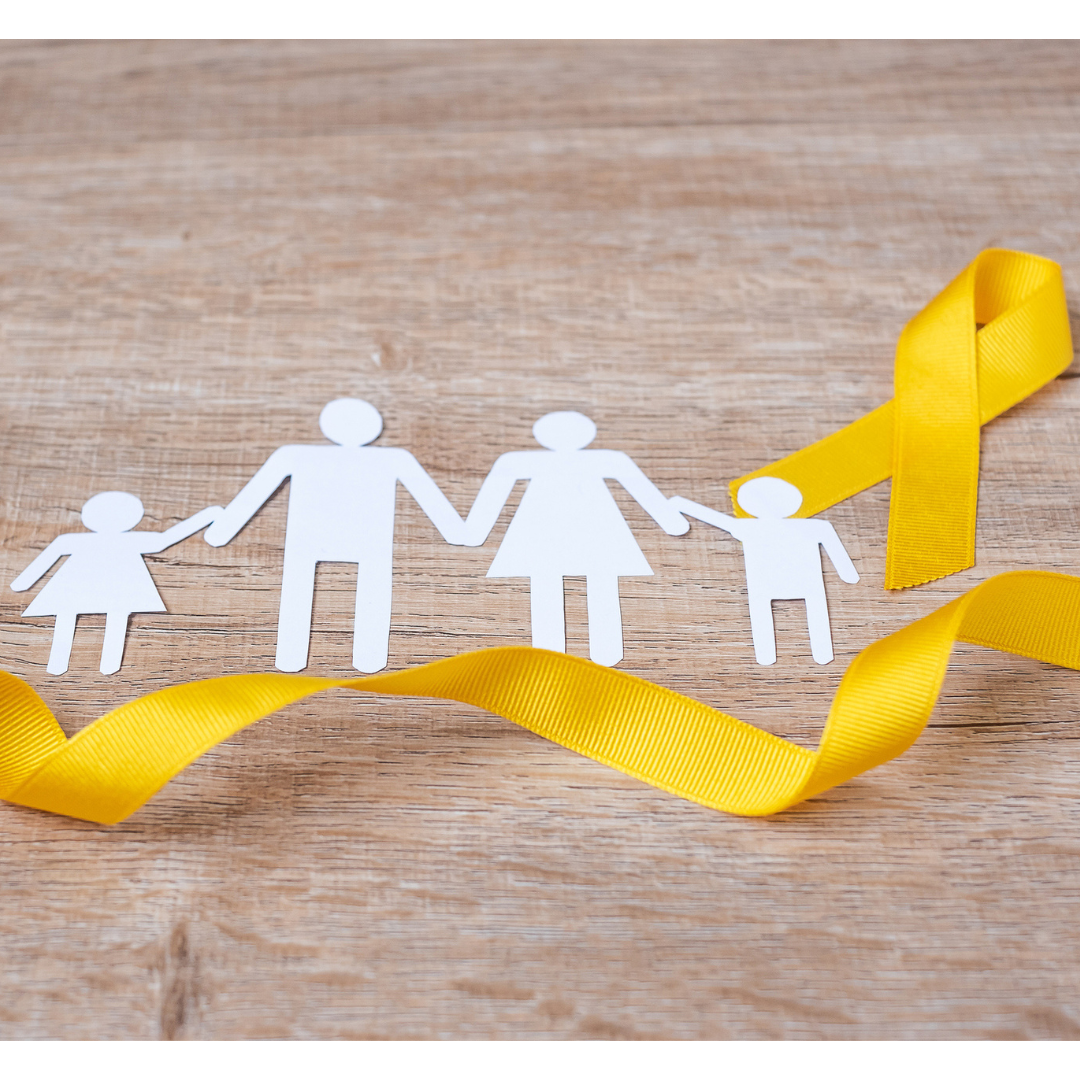 Image of cut-out paper figures, two adults and two children. They are surrounded by a gold ribbon.