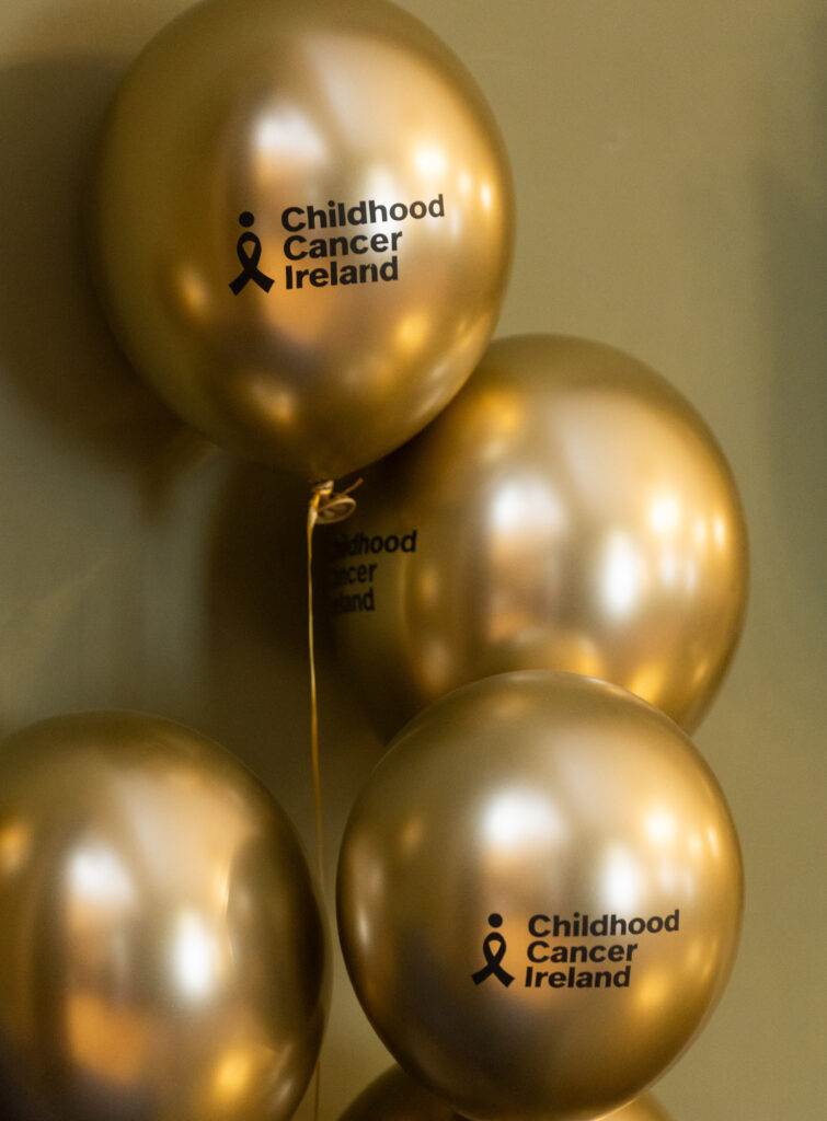 gold balloons with the childhood cancer ireland logo