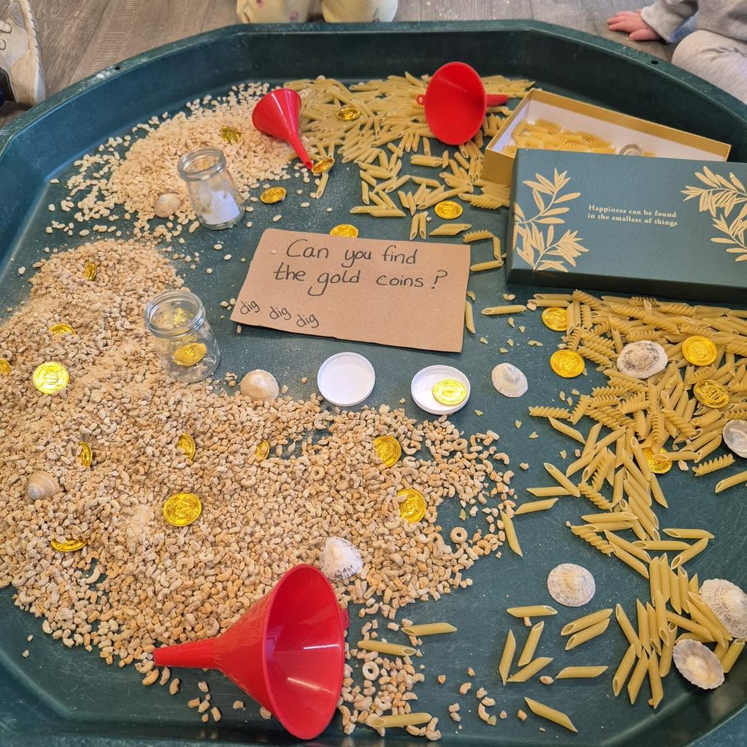 Tuff tray filled with gold activities